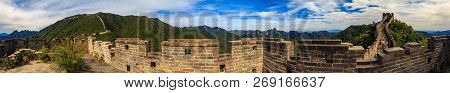 Panoramic View Of The Great Wall Of China And Tourists Walking On The Wall In The Mutianyu Village A