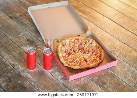Slice Pizza In Box And Can Of Soda On Wood Background