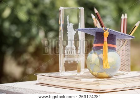 Learning Study International Abroad In America Concept: Graduate Cap On Earth World Globe Model Map 
