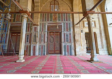 Cairo, Egypt - December 21, 2017:  The Carved Wooden Door With Ivory Inlay Is Surrounded By Colored 