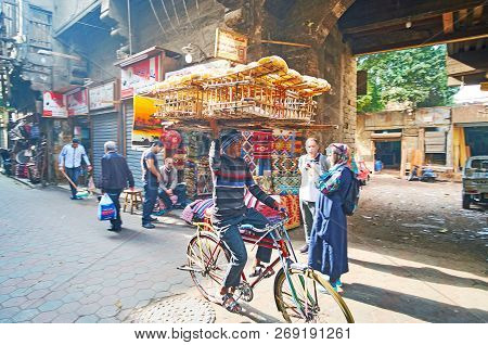 Cairo, Egypt - December 21, 2017:  The Young Deliveryman With Giant Basket, Full Of Hot Fresh Flatbr