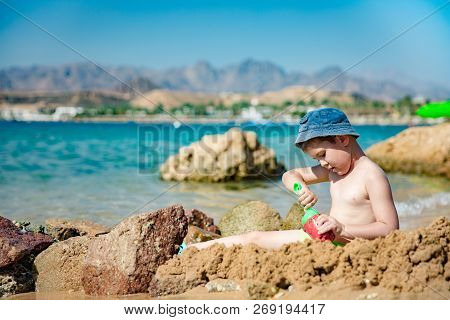 Little Boy Play With Sand On Summer Beach