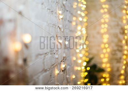 White Brike Wall With Blurred Background With Bokeh Lights, Electric Garland