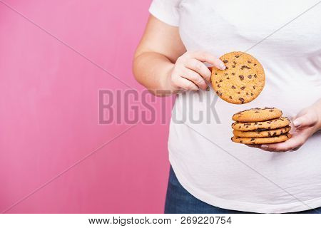 Weight Loss, Overweight, Plus Size, Diet, Unhealthy Eating. Fat Woman With Stack Of Chocolate Cookie