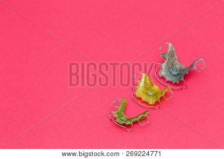 Colorful Dental Braces Or Retainers For Teeth On Pink Background, Copyspace