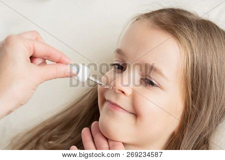 Runny Nose In Children. Mom Is Dripping In The Nose Girl Drops.