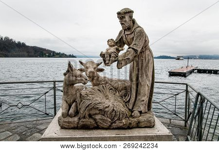 Statues Of Saint Francis With Jesus Child On Lake Maggiore In Laveno Mombello, Italy