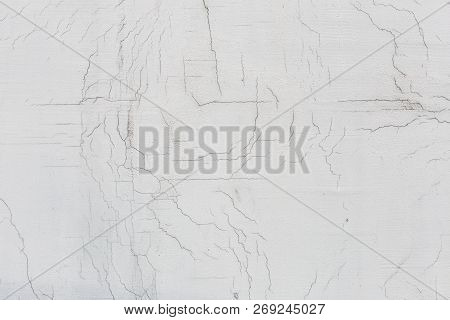 Texture Of White Dirty Cracked Wall. Small Straight Cracks. Direct Fracture On Painted Surface. Cell