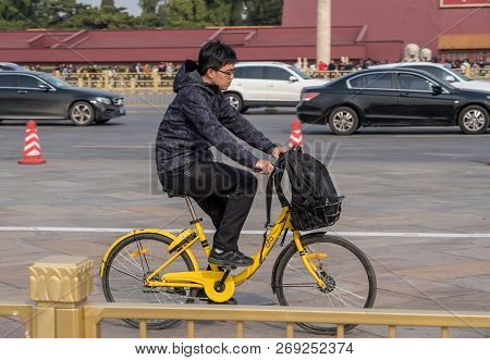 Beijing, China - 19 October 2018: Cyclist On Ofo Bike By Forbidden City In Tiananmen Square In Beiji