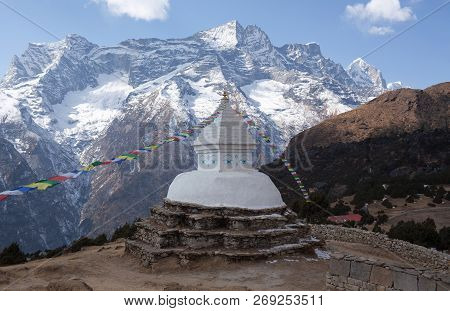 Buddhist White Stupa With Prayer Flags Above Namche Bazaar On The Way To Everest Base Camp, Sagarmat