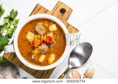 Goulash Soup On White Stone Table. European Cuisine. Top View With Copy Space.