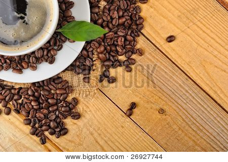 cup with coffee and coffee beans