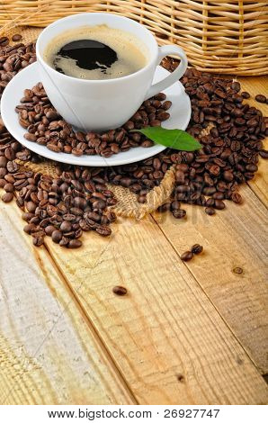 cup with coffee and coffee beans