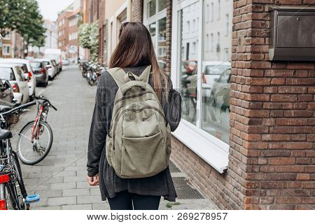 Tourist With A Backpack Is Looking For Booked Online Accommodation In An Unfamiliar City. Or A Stude