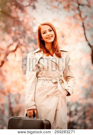 Style Redhead Girl With Suitcase On Autumn Season Park. Image With Filter