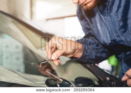Close Up Car Glaze Worker Fixing And Repairing A Windshield Or Windshield Of A Car At A Garage Servi