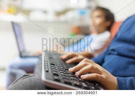 Boy typing on a wirelss keyboard