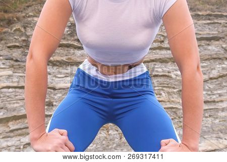 Flat Belly Girl During Diaphragmatic Breathing Exercises Bodyflex On The Rock Background. Belly Clos