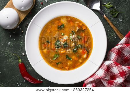 Traditional Hungarian Goulash Soup On The Table. European Cuisine. Top View With Copy Space,