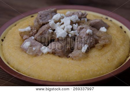 Polenta With Meat, Traditional Food, Over Rustic Wooden Background.