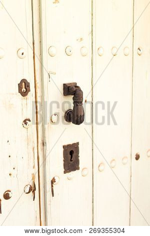 Close-up. Vintage Handle For Knocking On The Door In The Form Of A Hand.