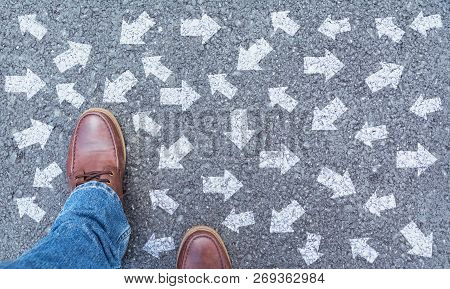 Top View Of Man Wearing Shoes Choosing A Way Marked With Arrows. Chooses The Right Path Concept.