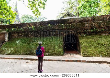 Traveler Woman Standing At Ancient Tunnel In Wat Umong Temple, Chiangmai, Thailand