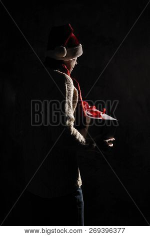 Christmas Gift Concept. Man In Santa Hat Bring Gift For You. Attractive Man Hold Box.  Christmas And