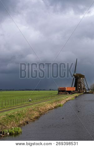 Windmill The Dikke Molen Near Alphen Aan Den Rijn With Some Heavy Rain Clouds Approaching