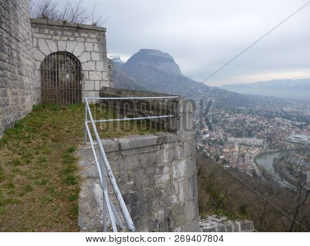 An Old Abandoned Closed Gate On A Stone Wall In Grenoble.