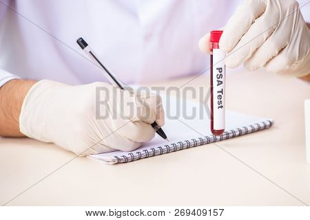 Young handsome lab assistant testing blood samples in hospital 