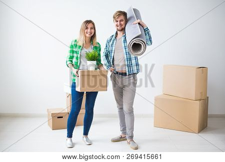 Relocation, Real Estate And Moving Concept - Young Cheerful Couple Moving Into Their New Home