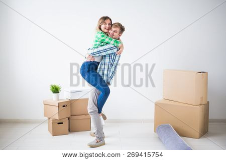 Relocation, Real Estate And Moving Concept - Young Cheerful Couple Moving Into Their New Home