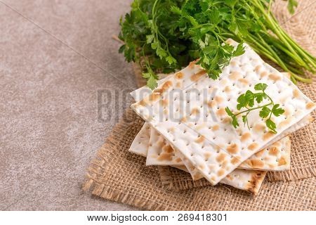 Traditional Jewish Kosher Matzo With Bunch Of Fresh Parsley