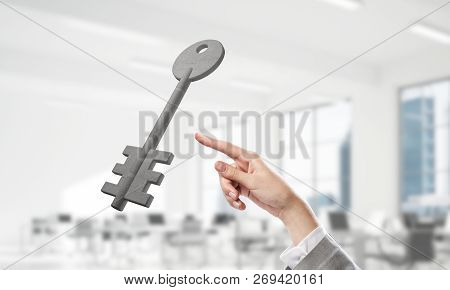 Cropped Image Of Businessman In Suit And Stone Key Symbol. Mixed Media