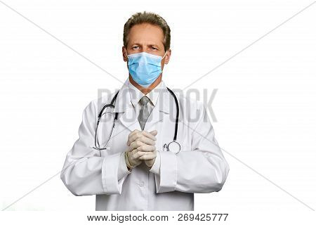 Portrait Of Doctor With Clasped Hands. Professional Male Doctor Wearing White Coat And Medical Mask 