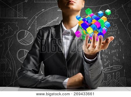 Cropped Image Of Business Woman In Suit Presenting Multiple Cubes In Hand As Symbol Of Innovations. 