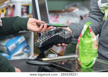 Contactless Payment Using Smartphone And Electronic Payment Terminal In Store. Nfc And Paypass