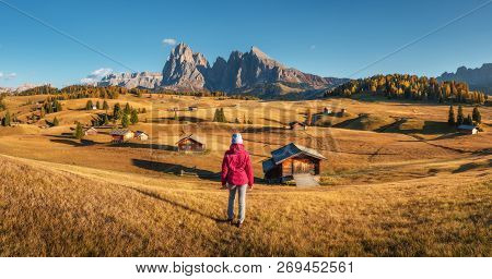 Young Woman Looking In Meadows And Mountains At Sunset In Autumn