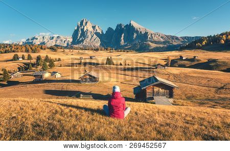 Young Woman Looking In Meadows And Mountains At Sunset In Autumn
