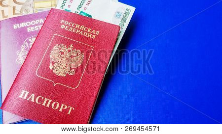 Passports On The Blue Background. Citizenship Of Estonia And Russia. Citizenship Of European Union (