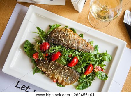 Delicious Seared Fish Fillet With Wine On Restaurant Background.