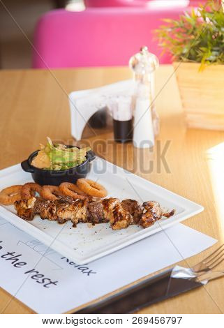 Pork Kebabs, Bbq Meat On Plate With Crunchy Deep Fried Squid Ring In Batter With A Delicious Sauce.
