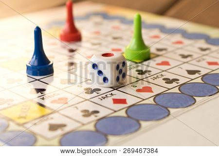 Multi-colored Game Chips With Dice On The Playing Board. Board Game