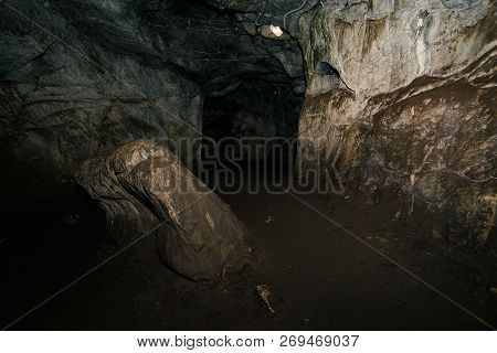 Beautiful Cave. View From Inside Dark Dungeon. Textured Walls Of Cave. Background Image Of Undergrou