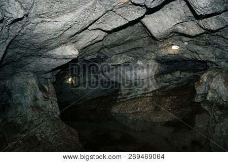 Beautiful Cave. View From Inside Dark Dungeon. Textured Walls Of Cave. Background Image Of Undergrou