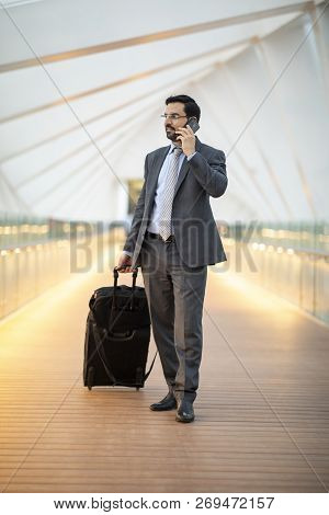 Arab Businessman With His Suitcase On A Phone