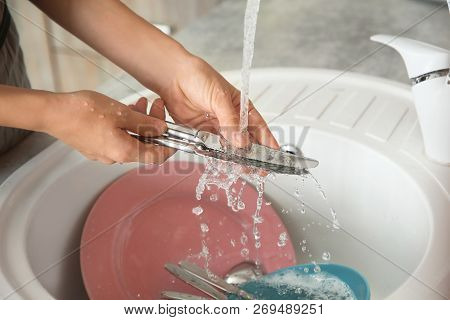 Woman Washing Dishes In Kitchen Sink, Closeup View. Cleaning Chores