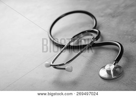 Stethoscope For Checking Pulse And Space For Text On Gray Background