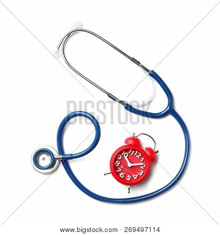 Stethoscope And Red Alarm Clock For Checking Pulse On White Background, Top View